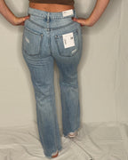 Person wearing blue jeans with a white background