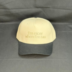 Beige and black cap with text on a gray background