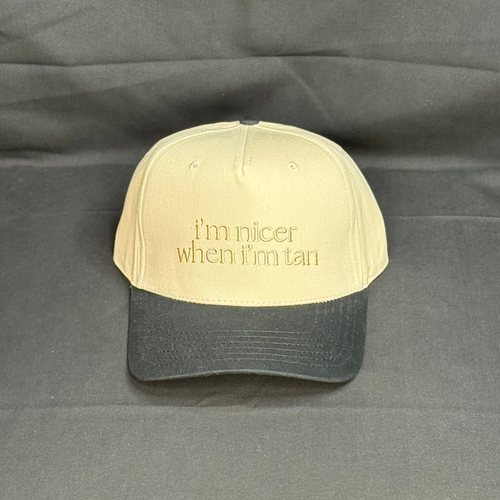 Beige and black cap with text on a gray background