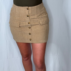 Beige corduroy skirt with button details on a plain background