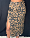 Leopard print skirt with a slit on a dark background