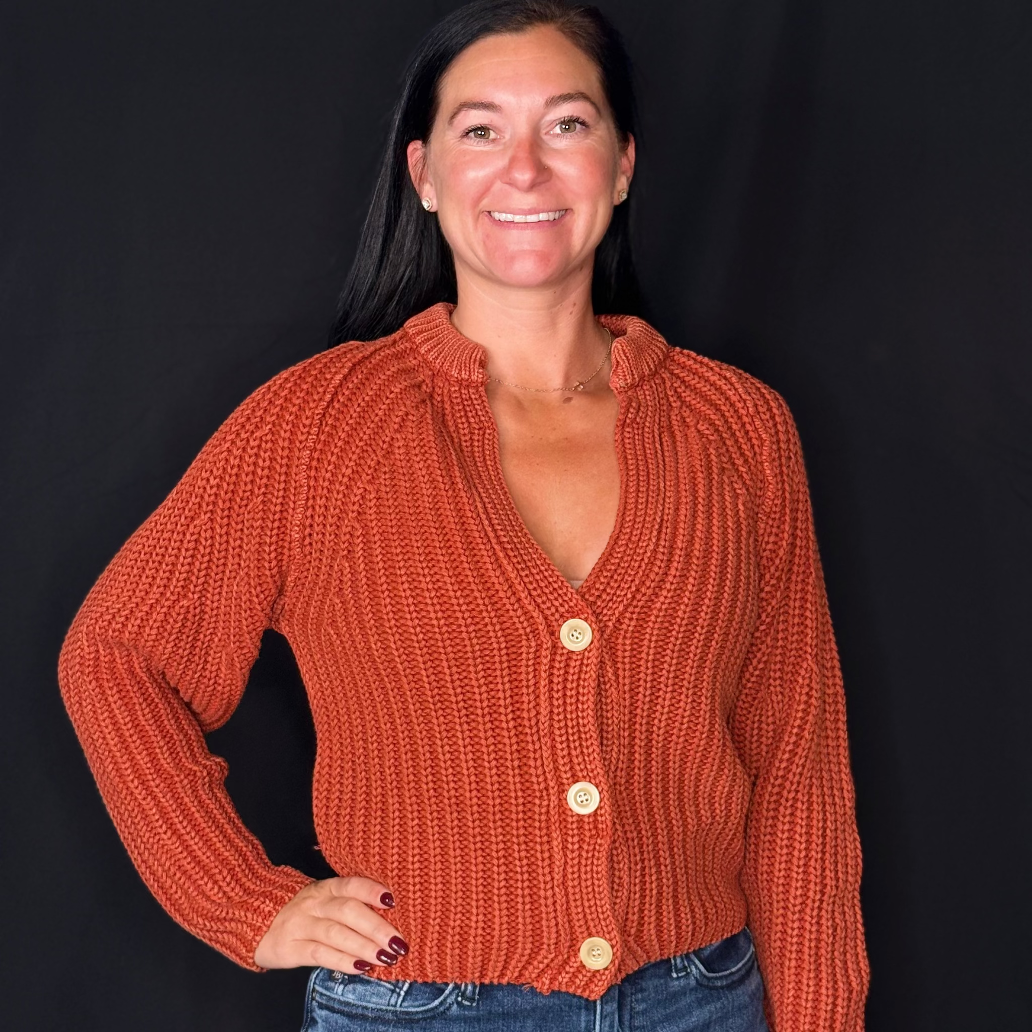 rust-colored knitted cardigan