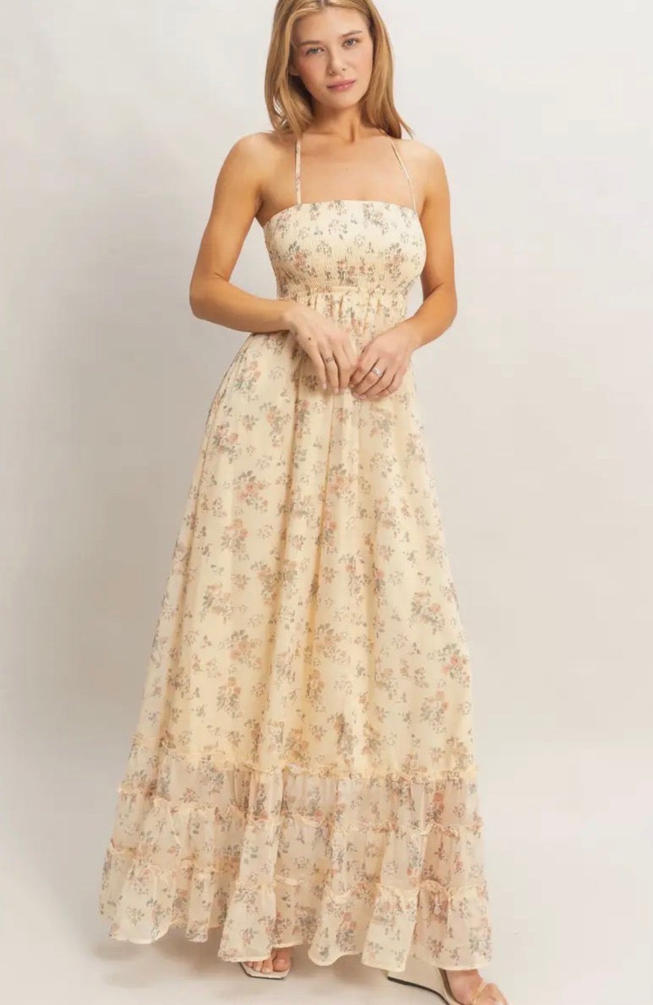 Woman wearing a floral dress on a plain background