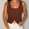 Brown knitted tank top worn by a person on a plain background